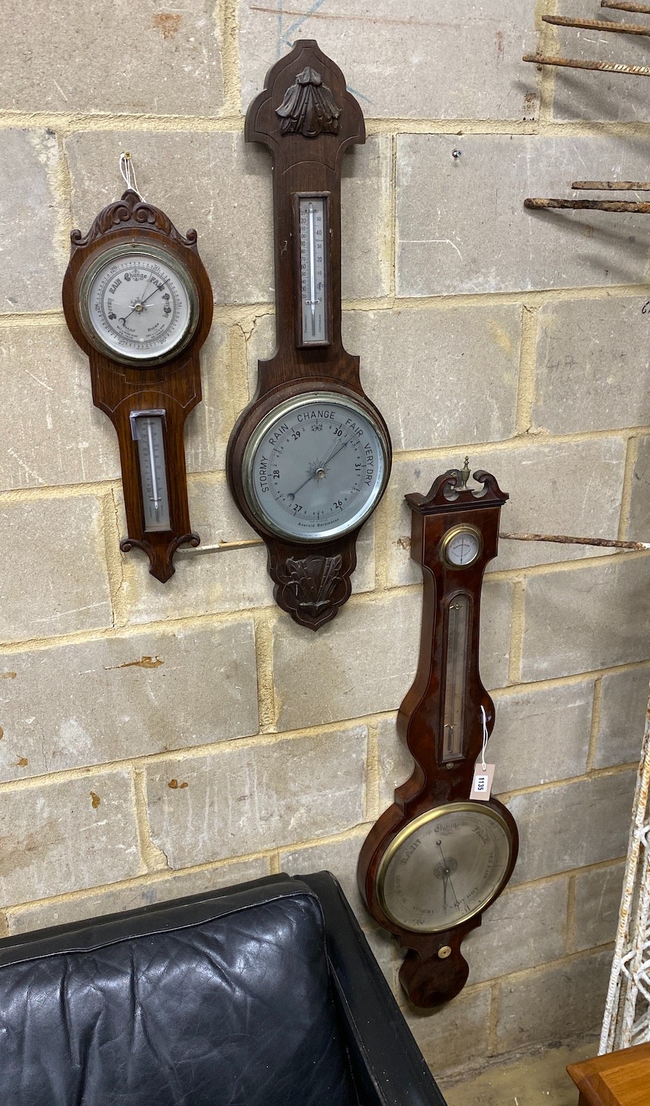 An early 19th century mahogany wheel barometer, height 112cm together with two later oak aneroid barometers